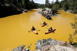 People kayak in the Animas River near Durango, Colo., Thursday, Aug. 6, 2015, in water colored from a mine waste spill. The U.S. Environmental Protection Agency said that a cleanup team was working with heavy equipment Wednesday to secure an entrance to the Gold King Mine. Workers instead released an estimated 1 million gallons of mine waste into Cement Creek, which flows into the Animas River. (Jerry McBride/The Durango Herald via AP) 